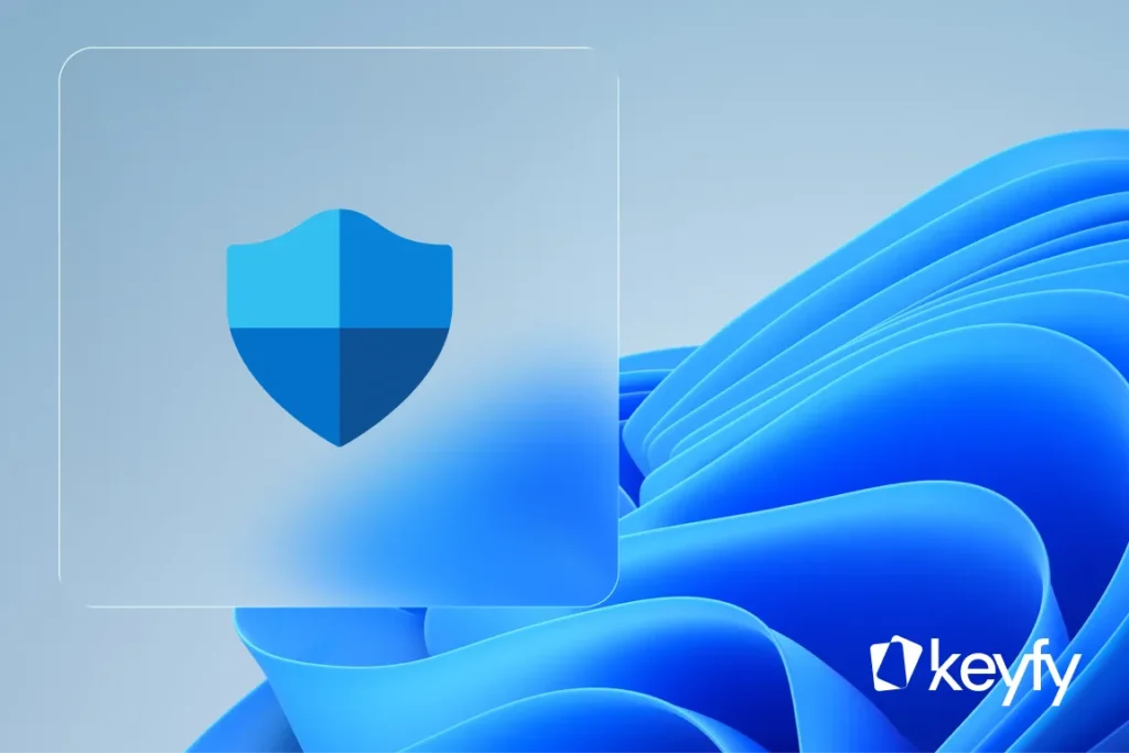 Icône de bouclier numérique sur fond bleu, évoquant la sécurité pour comparer Windows 11 Home et Pro. Logo keyfy en bas à droite.